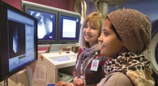 Student with clinical instructor looking at images on a computer